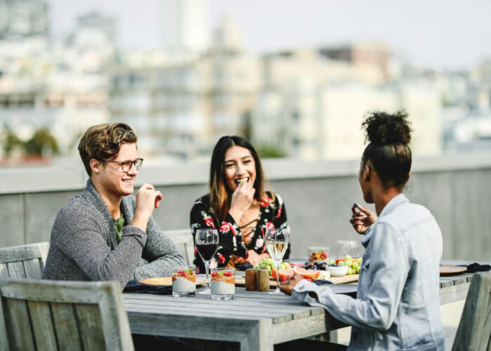 Photo of group of people on a rooftop deck enjoying the best outdoor dining in San Francisco